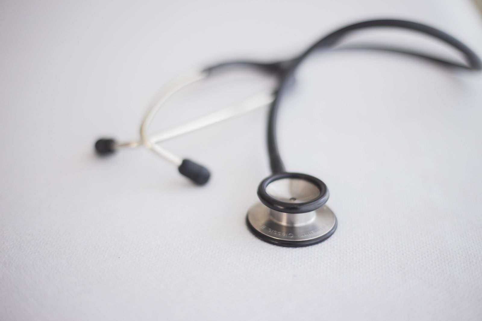 A stethoscope on a pale surface